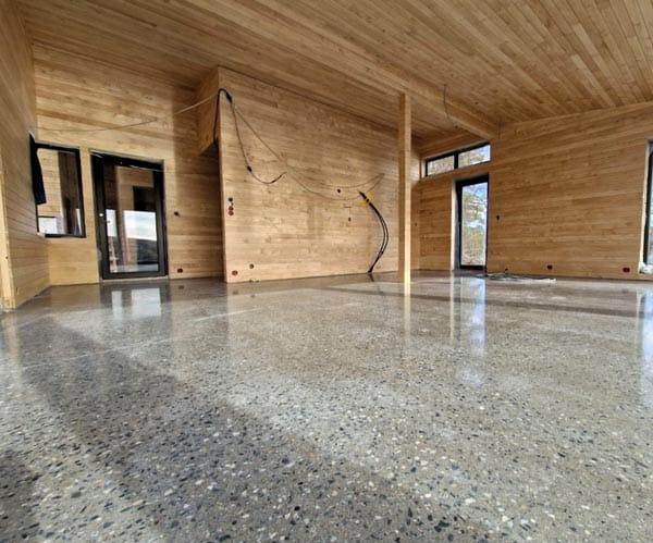 A new room in light wood panelling with a polished concrete floor