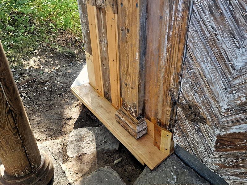 A new sill beam fitted under the old corner of a timber wall